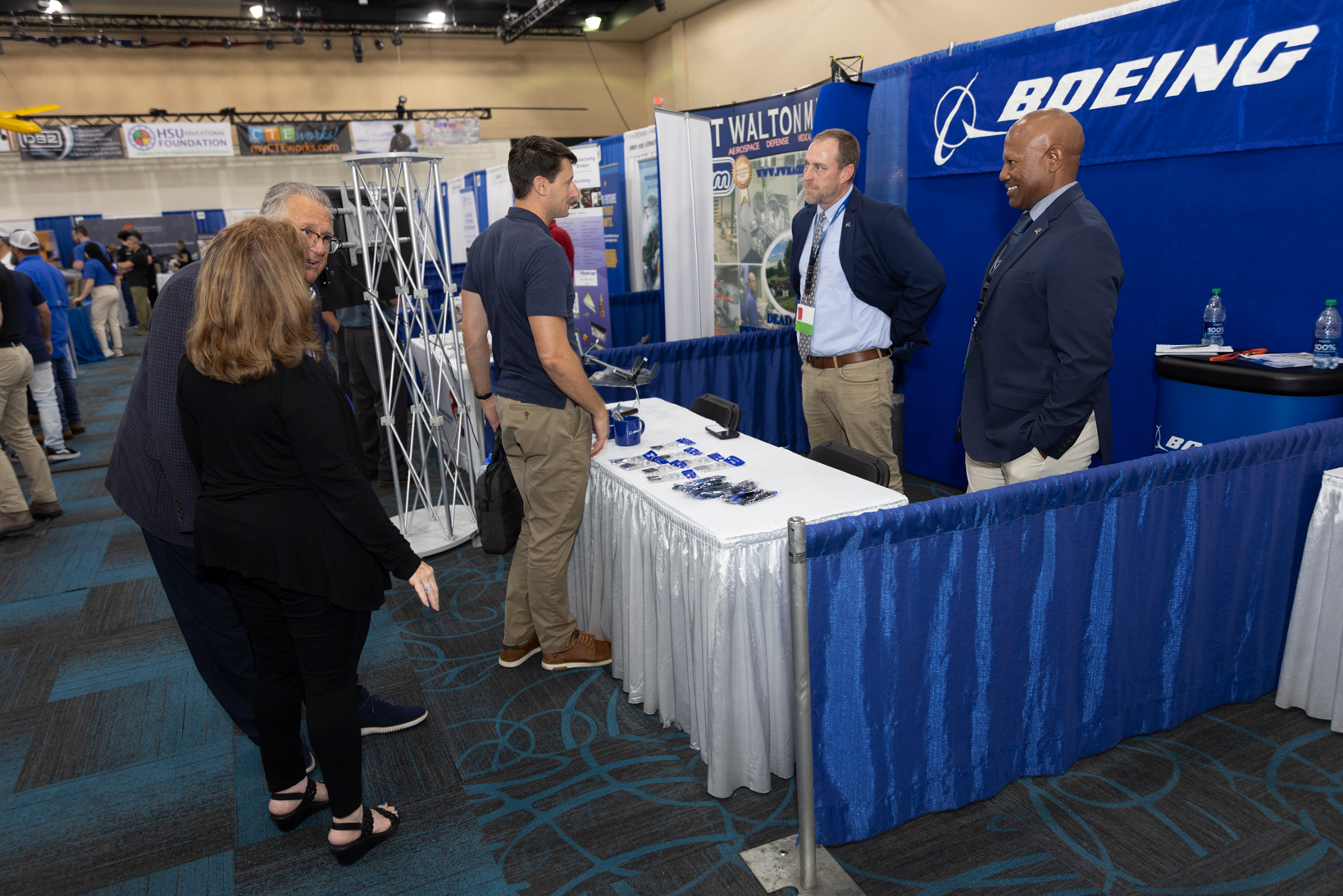 2 men at a conference booth at the TeCMEN Industry Day